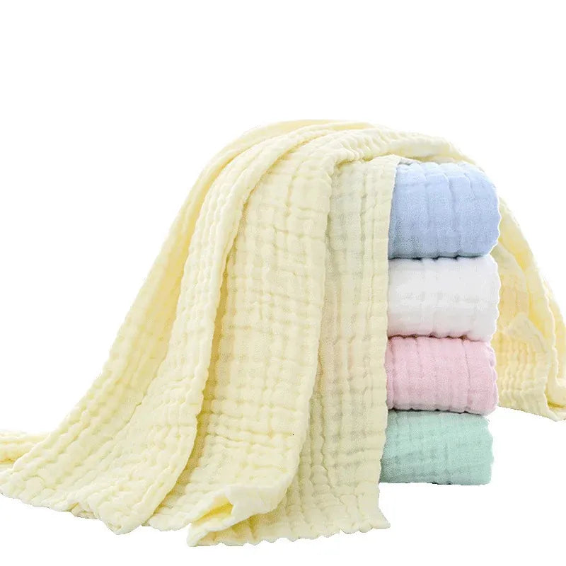 Stack of colorful baby blankets on a white background