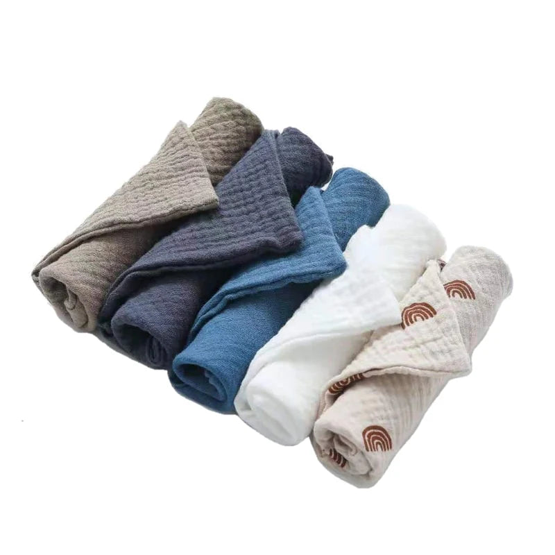Set of folded baby blankets in various colors on a white background