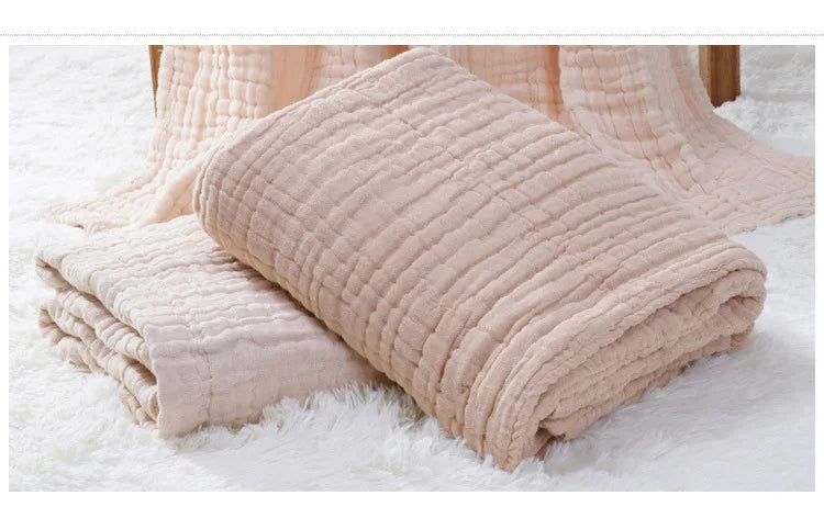 Beige textured blanket on a white surface