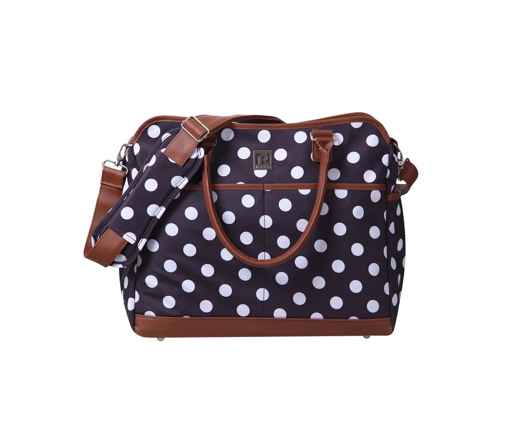 Polka dot bag with brown handles and strap on a white background